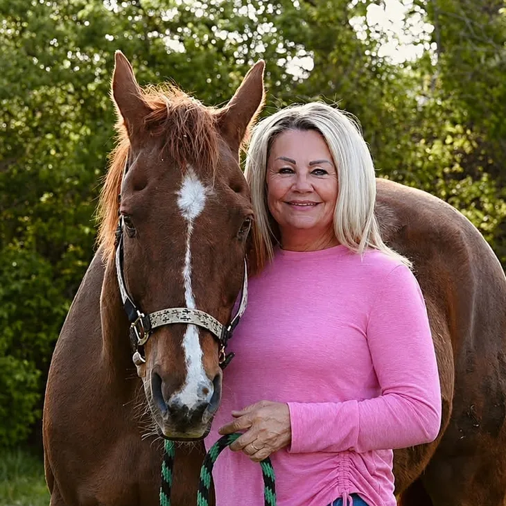Lady and horse in green landscape