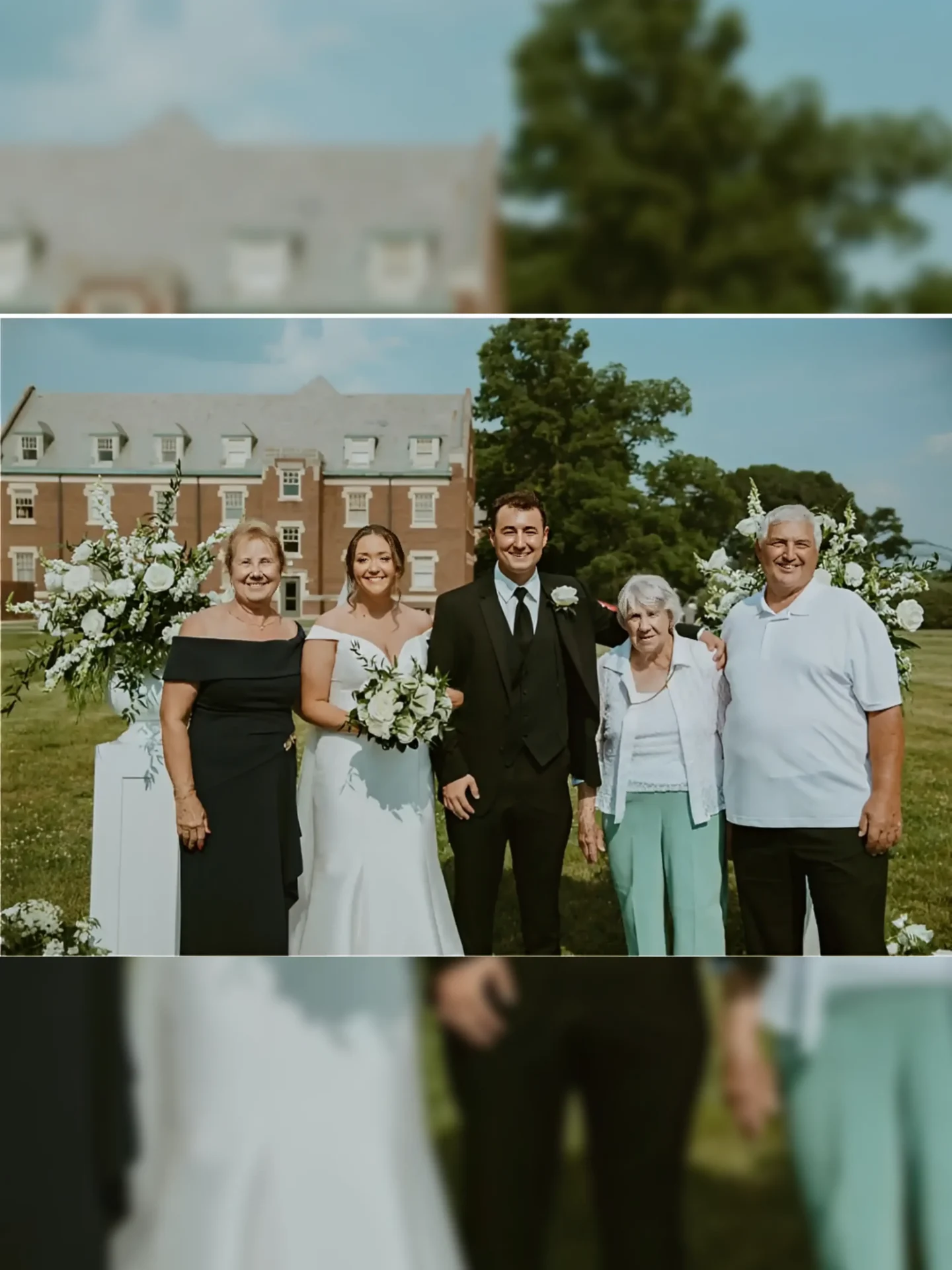 Bride and groom with family outdoors
