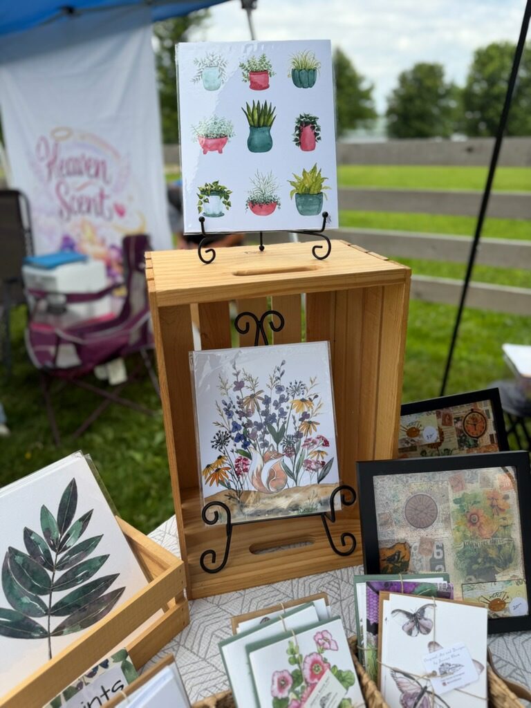 Outdoor booth displaying botanical and floral prints