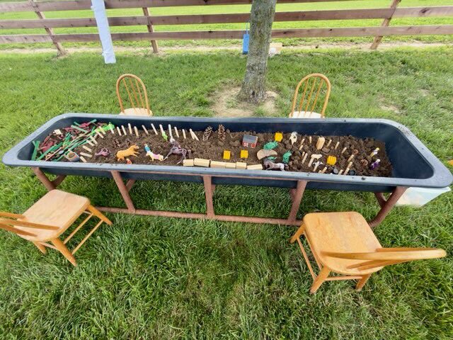 Outdoor sensory play sandbox with chairs
