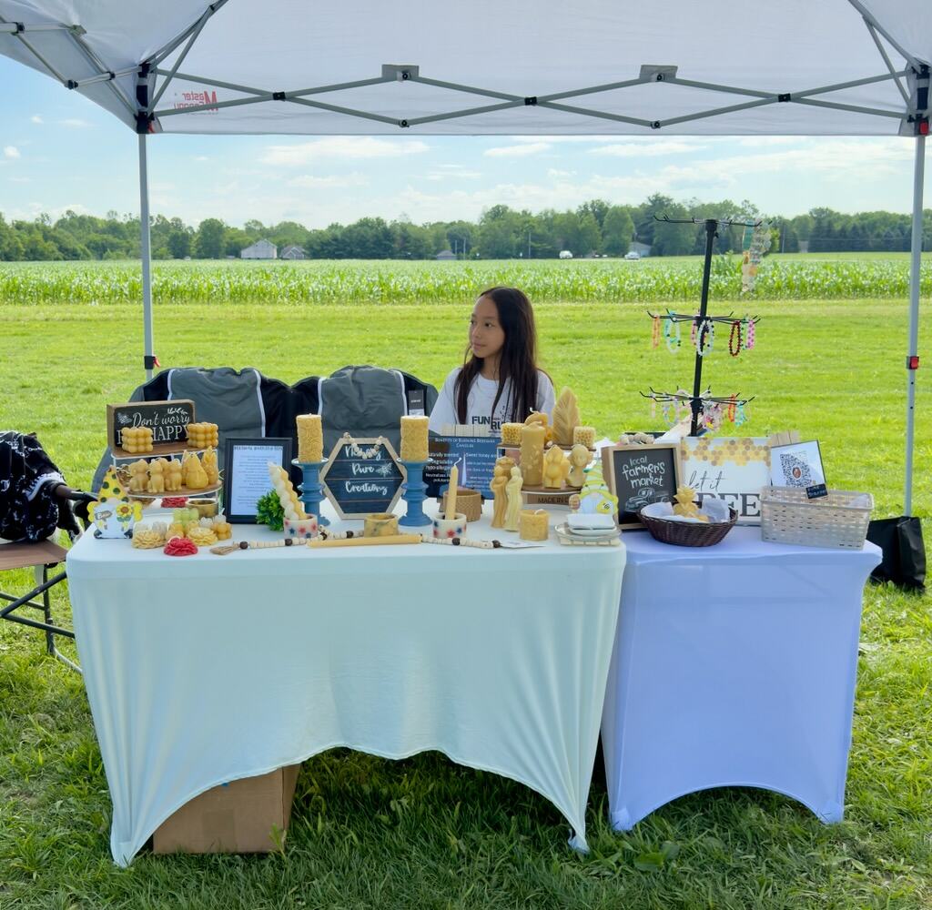 Outdoor market stall with girl selling crafts